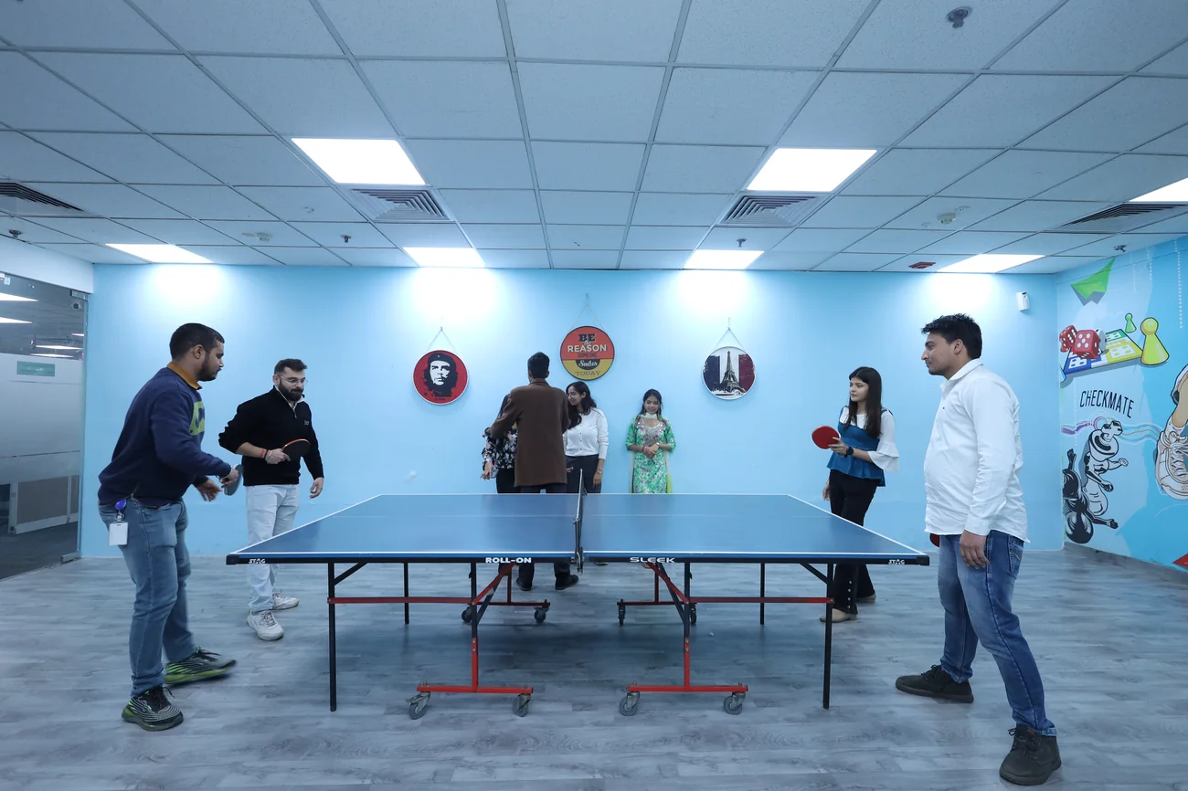 Resourcifi team playing table tennis in the office fun room