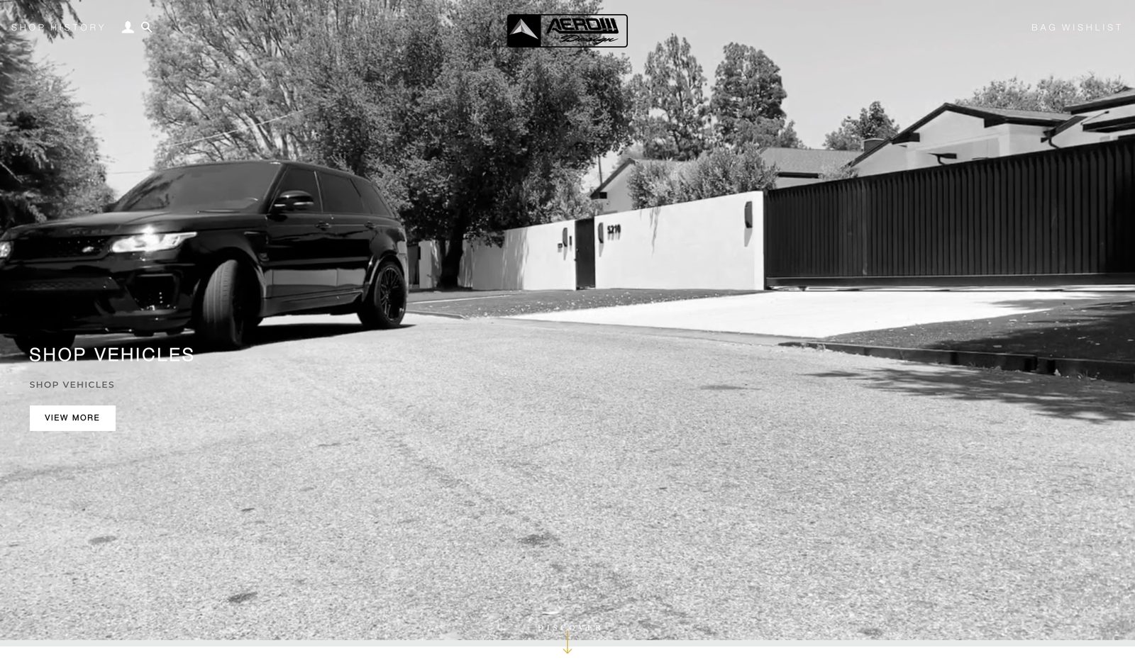 AEROW Design homepage hero in black and white showing a blacked-out Range Rover Sport in a driveway with the centered AEROW Design logo and a SHOP VEHICLES VIEW MORE button