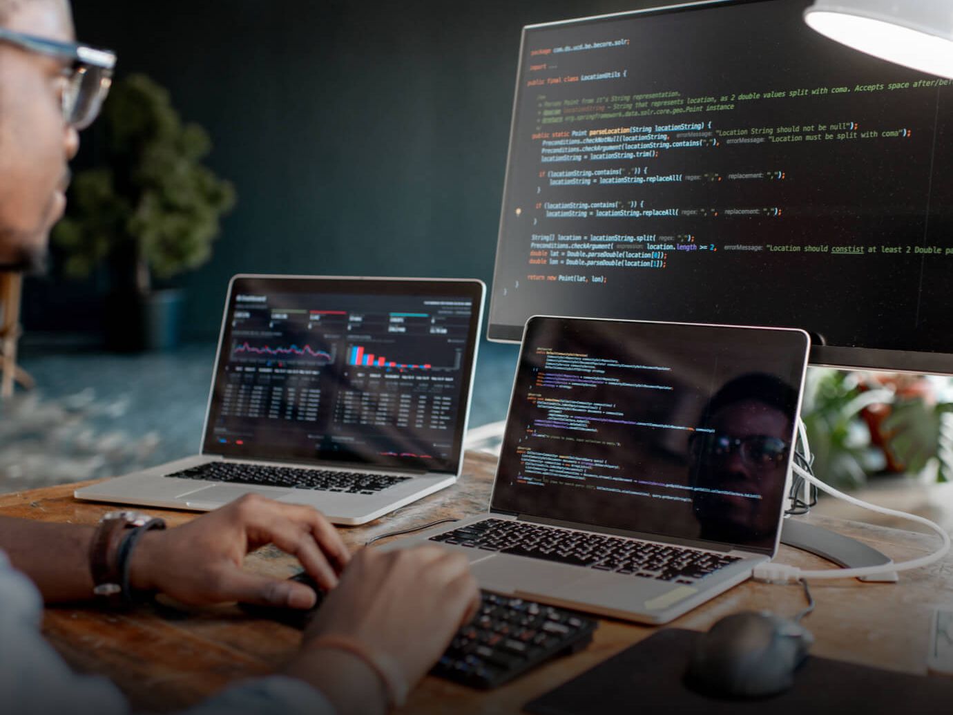 Web development team building a website on laptops, code on screen